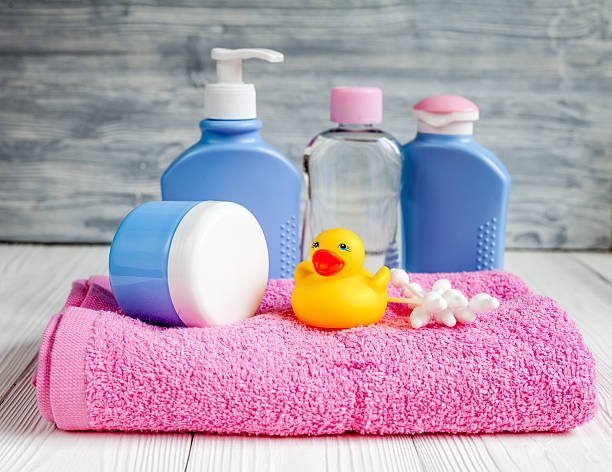 baby organic cosmetic for bath on wooden background close up